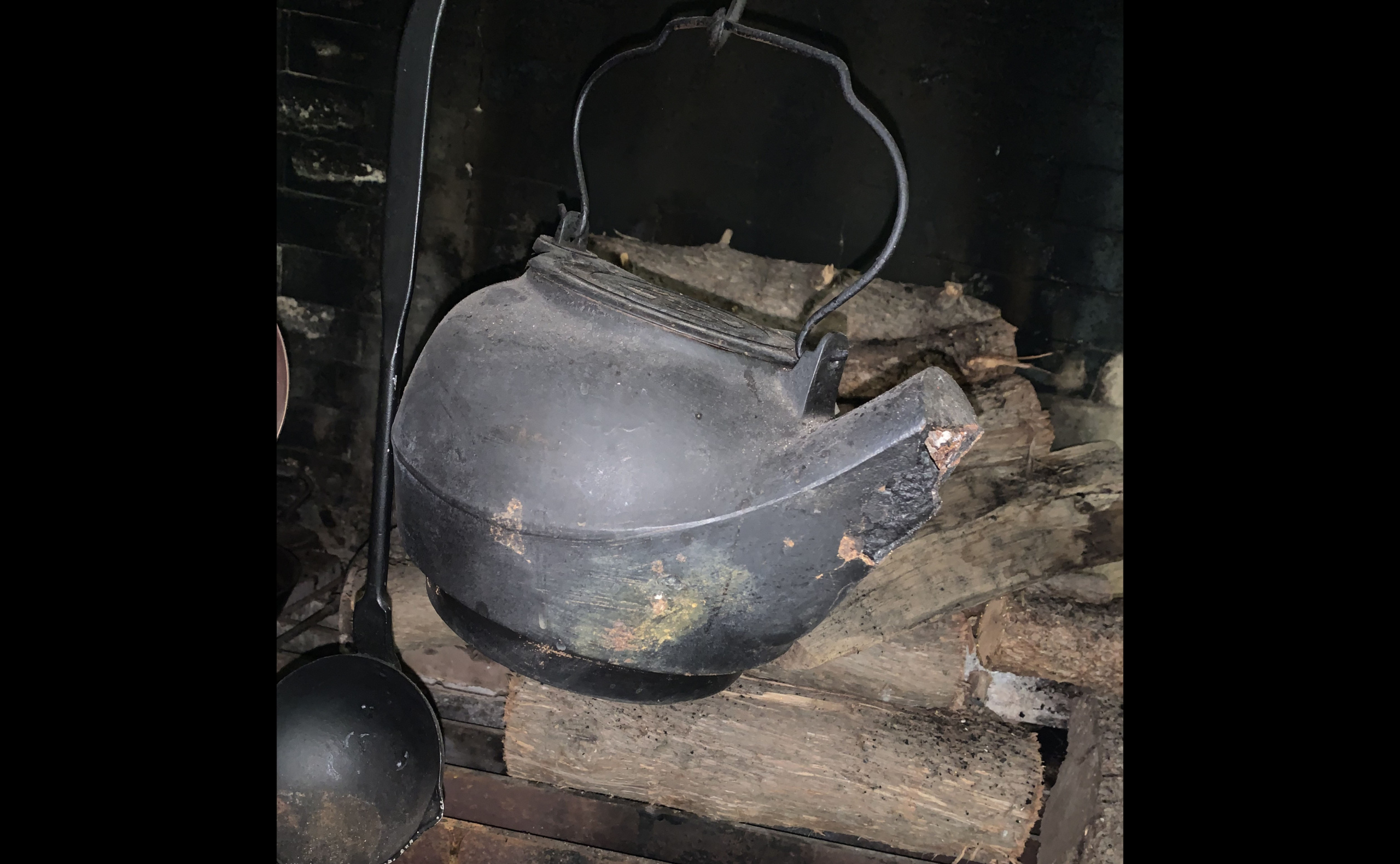 Copper kettle over an open fire in winter. Boiling kettle on