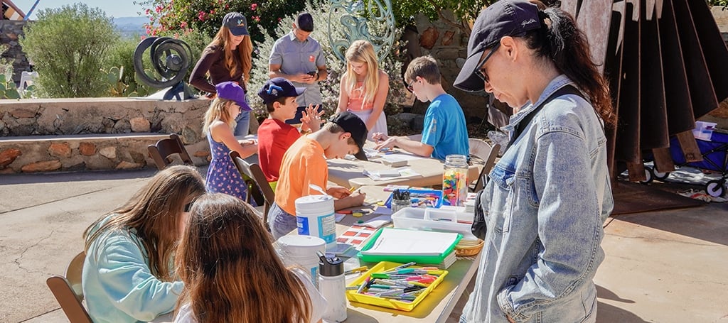 children and adults creating art during a family workshop program