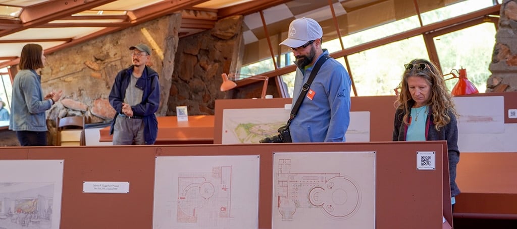 visitors in the drafting room at Taliesin West learning more about Frank Lloyd Wright