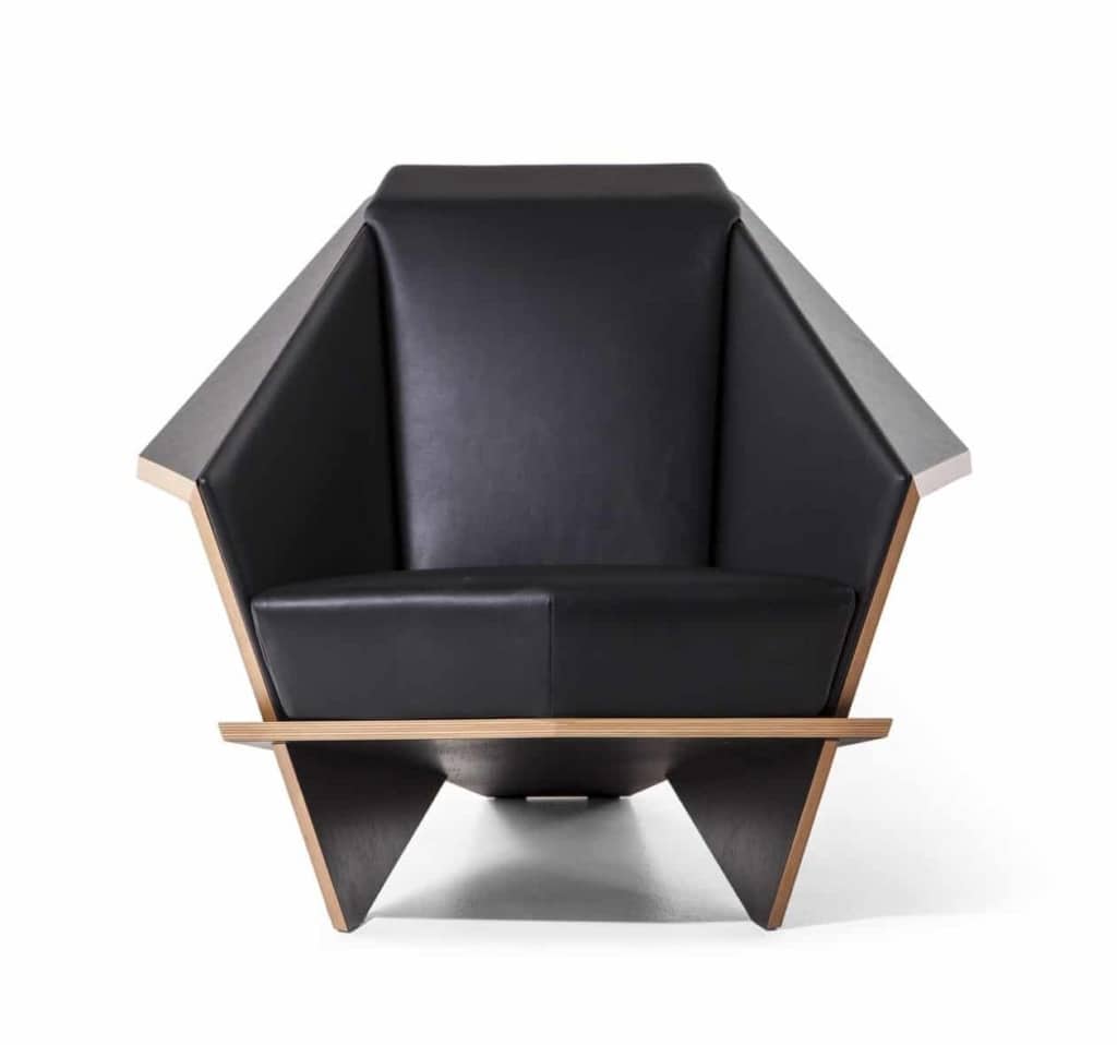 The Taliesin 1 chair front: a photo of the chair with black cushion, and a light wood accent along the edge.