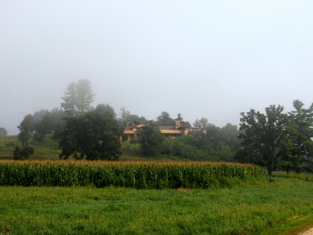 Frank Lloyd Wright's Wisconsin home, Taliesin, is seen in fog, across a field of corn