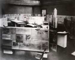 View of exhibition with drawings hanging on pinboard walls.