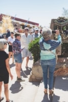 Visitors on a tour at Taliesin West, one taking a photo of a Chinese theater frieze
