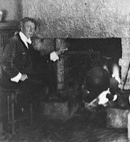 frank lloyd wright standing next to a fireplace