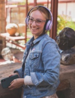 woman with headphones on audio tour