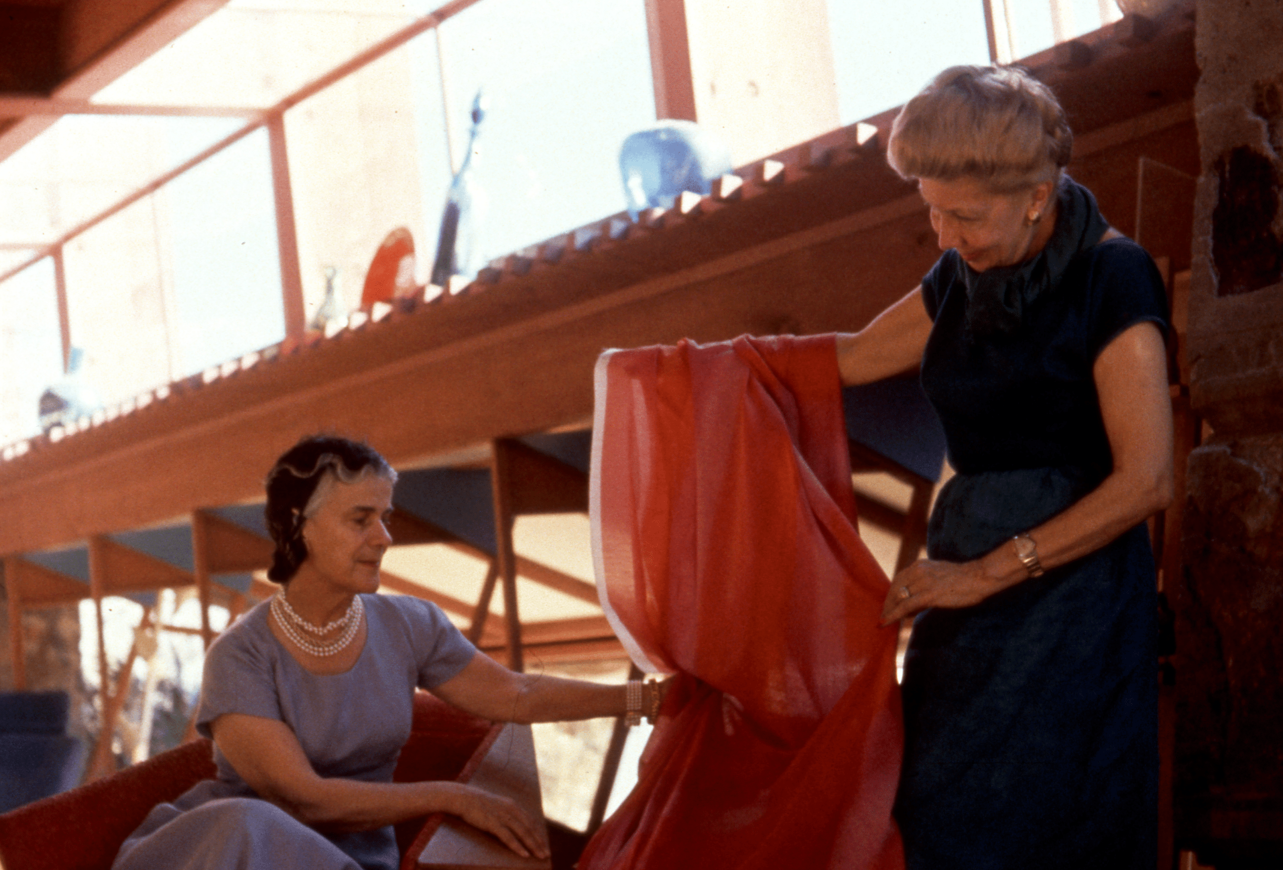 Liebes showing a textile to Olgivanna Lloyd Wright at Taliesin West