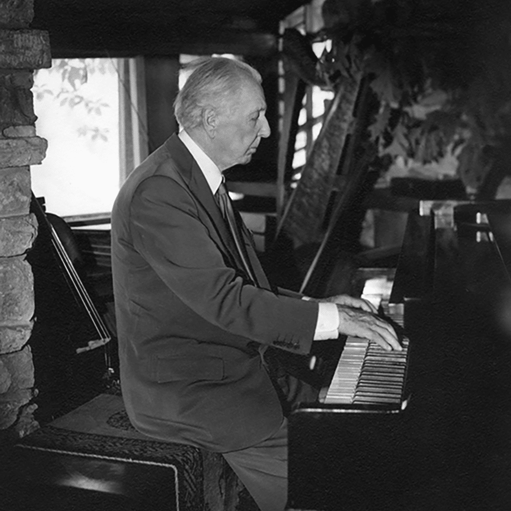 Frank Lloyd Wright playing piano at Taliesin
