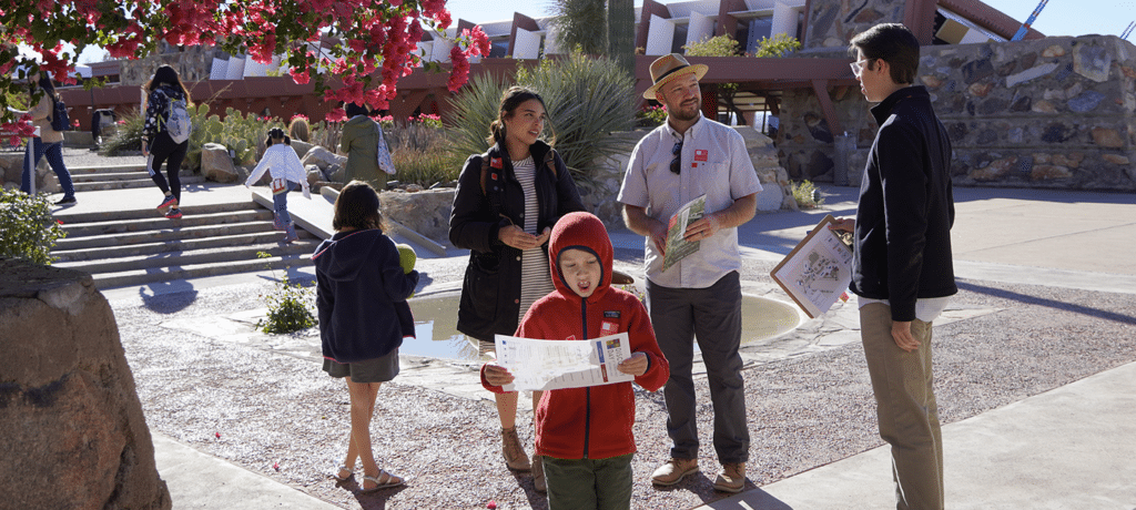 a family with young children talking with a guide prior to entering the property at Taliesin West