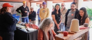 visitors watching a weaving demonstration