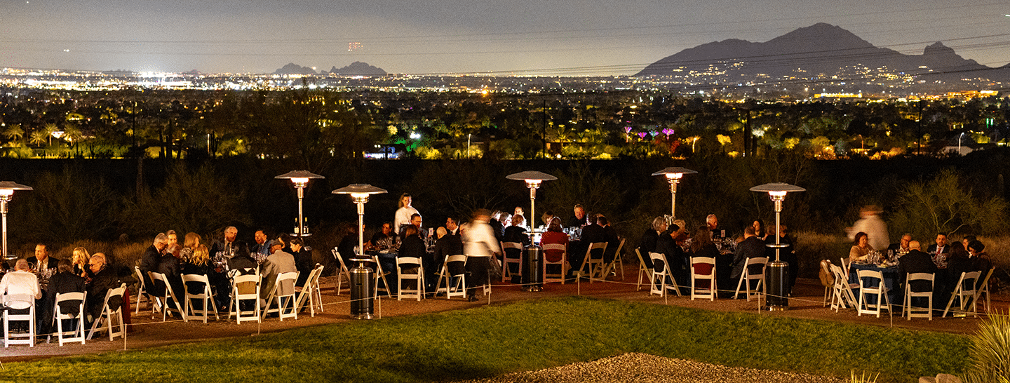Large corporate evening dinner on the Prow at Taliesin West, with the light in the distance from Scottsdale and Phoenix