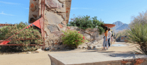 Two guest, walking and listening to content on a self guided audio tour